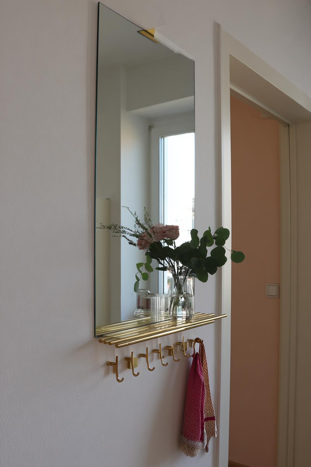 13. Spiegelwand im Flur mit Hakenleiste aus Messing und Ablagekonsole